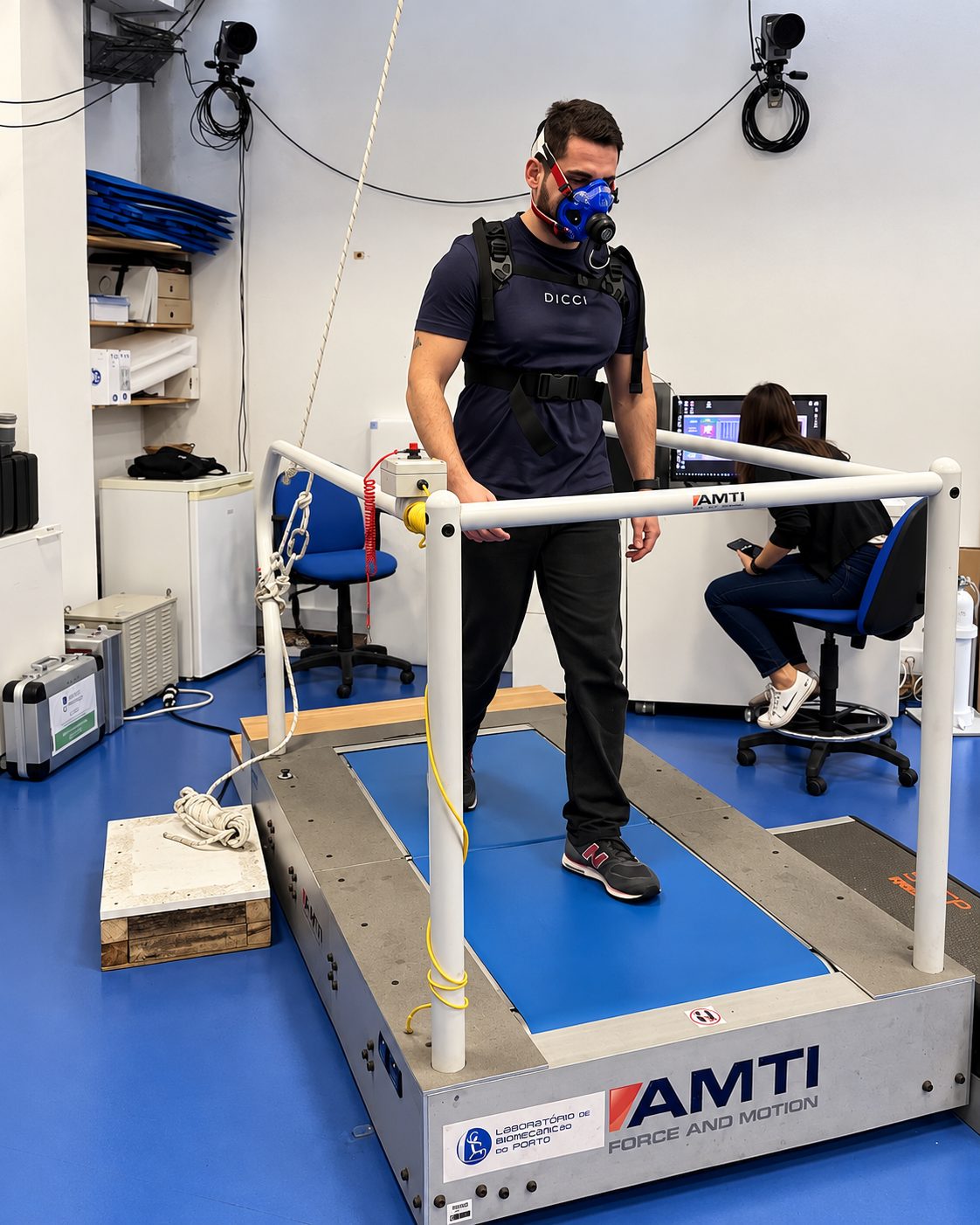 A participant walking on an instrumented treadmill while wearing respiratory measurement equipment during a KinetikOS validity study.